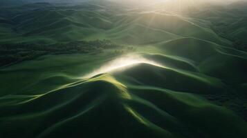 An aerial view of a green hill with sun shining photo