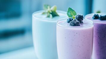 Three smoothies with berries and mint leaves photo