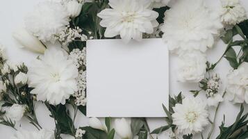 White flowers and a blank note on a white background photo