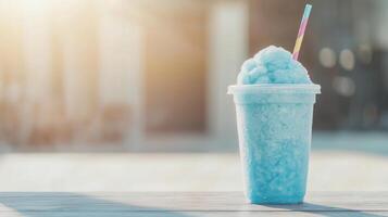 A blue smoothie with a straw sitting on a table photo