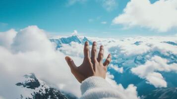 A person reaching up to the clouds photo