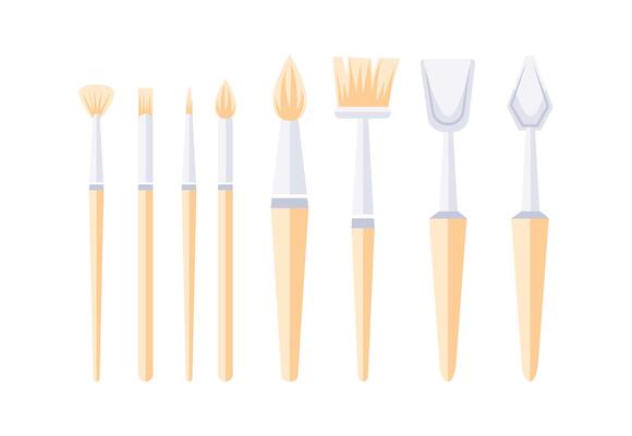 Paint brushes and palette knives forming a colorful set of tools for creating art