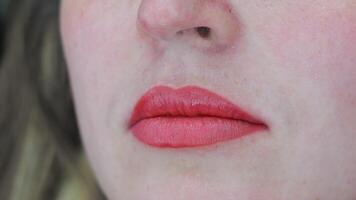 Closeup of healed lips after permanent makeup, smooth red tone and well-defined contour visible on skin video