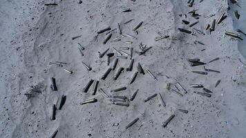 The symbol of the war. Empty cases from automatic weapons remaining in the sand after the fight video