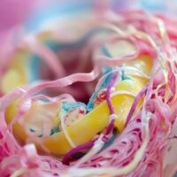 A donut with a pink and yellow icing photo