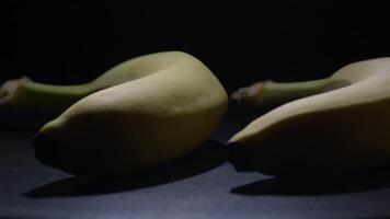 Row of bananas fruit gyrating with black background video