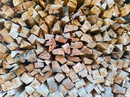 Stacked firewood creating a rustic and warm atmosphere ideal for cozy evenings and winter fires in a serene forest setting photo