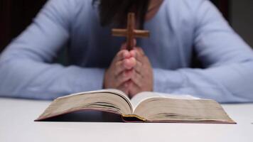 Christian man praying with cross over open bible video