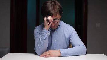 Man contemplating with rosary beads at desk video