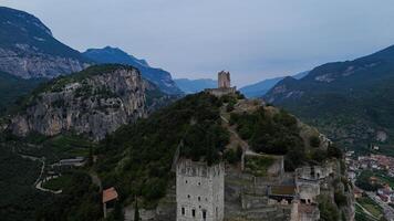 Exploring ancient ruins atop a majestic mountain overlooking a serene valley at twilight photo