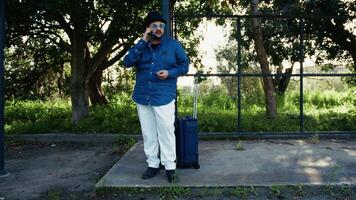 Man Talking At The Phone While Waiting For The Bus video