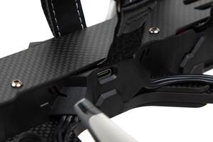 USB-C port on FPV drone carbon frame close-up photo