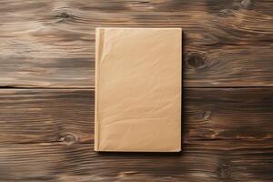 Closed beige book with crumpled paper cover on rustic wood table, top-down view photo