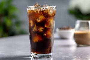 Cold brew coffee in a tall glass with ice cubes minimal background with soft reflection on glass surface photo