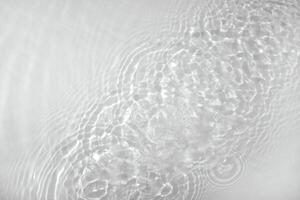Background with clear water. Water background with small bubbles. transparent water surface with splashes and wave texture with ripples. Top view, a place to copy photo