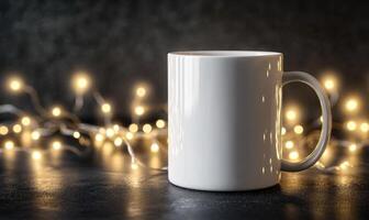 A white coffee mug sits on a table with a string of lights behind it photo