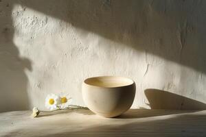 A single handmade clay cup with chamomile tea and flowers. Modern minimalism. photo