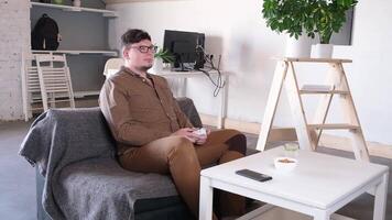 Focused Caucasian man playing games using controller at home video