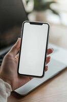 Hand Holding Isolated iPhone With Blank Screen photo
