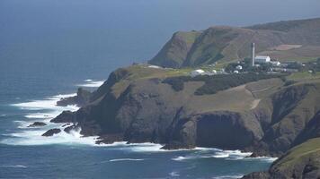 Aerial View of Coastal Cliffs and Lighthouse photo