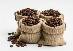 Four Burlap Sacks of Coffee Beans with Scattered Beans photo