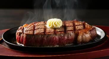 A succulent ribeye steak, fresh off the grill, sits on a cast iron skillet, topped with a melting pat of butter. photo