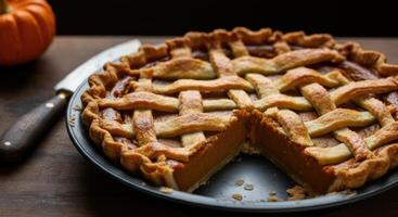 A delicious pumpkin pie with a golden-brown lattice crust photo