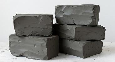 Stack of Clay Blocks on a White Surface for Sculpting Material photo