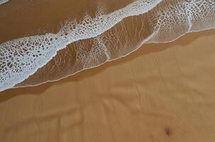 HIght angle view of sea waves at the beach photo