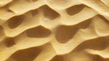 Close-up of smooth sand dunes with rippled patterns and soft shadows in desert landscape photo