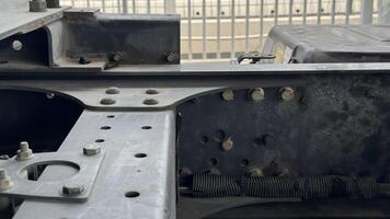 Truck Chassis Frame Details A close-up image showcases the intricate structural details of a heavy-duty truck chassis frame, highlighting the robust engineering and durability of the vehicle. photo