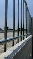 Protective Barrier and Structure A striking image of a modern metallic fence, creating a rigid barrier, highlighting the precision of design, construction, and solid foundation. photo