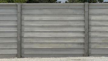 Concrete Panel Fence A sturdy and modern concrete panel fence with horizontal design a symbol of structure and privacy stands as a robust barrier photo