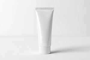 A tube of white cream on a white surface photo