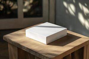 A white box sitting on top of a wooden table photo