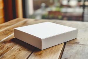 White box mockup on wooden table photo
