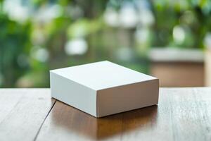 White box on wooden table with blurred background photo