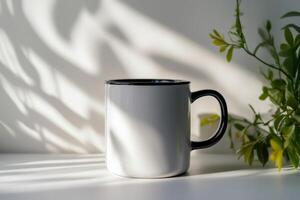 A white coffee mug with a black handle sitting on a table photo