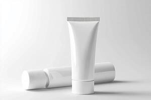 A tube of cream and a tube of toothpaste on a white background photo