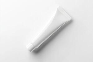 A tube of toothpaste on a white surface photo