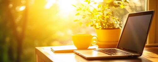 Cozy workspace with laptop, coffee cup, and branding notebook near a sunlit window in a serene setting photo