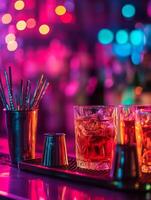 Bitters and garnish tray glowing under vibrant neon lights in a lively bar setting photo