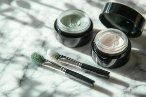 Face rollers, creams, and jars arranged neatly on a marble surface for skincare routine enhancement photo