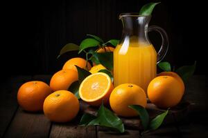 close up of a jug of fresh orange juice with ripe oranges and leaves around it stands on a wooden table photo in a dark key
