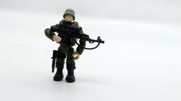 4. Plastic soldier toy holding weapon isolated photo