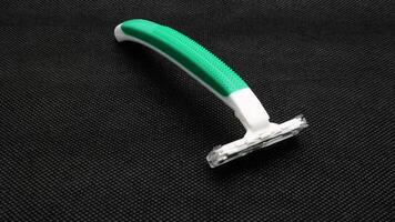 14. Razor and shaving cream on black background photo