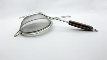8. Stainless spatula and strainer isolated photo