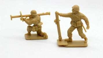 3 Plastic soldier toy holding weapon isolated photo