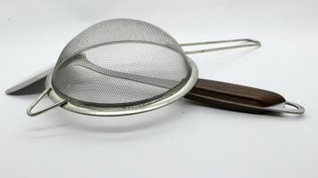 16. Stainless spatula and strainer isolated photo