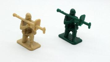 2 Plastic soldier toy holding weapon isolated photo